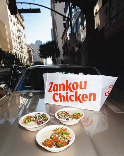 Zankou Chicken meals and branded bags styled on a vintage car